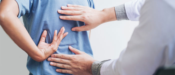 person with scoliosis getting back evaluated